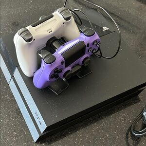 Sony PlayStation 4 Console with Black and Purple Controllers